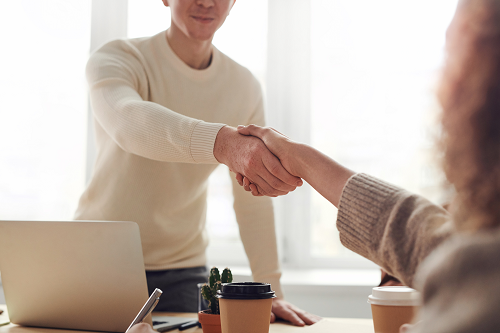 a person shaking hands in an office