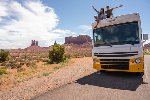 an rv traveling down a dirt road